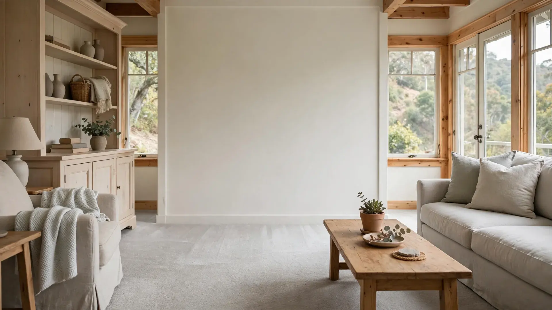 Clean light carpet in a bright Oakland living room with window light and a tidy sofa